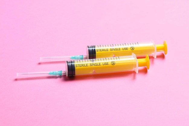 Top view of medical syringes on colorful background with copy space Injection equipment concept