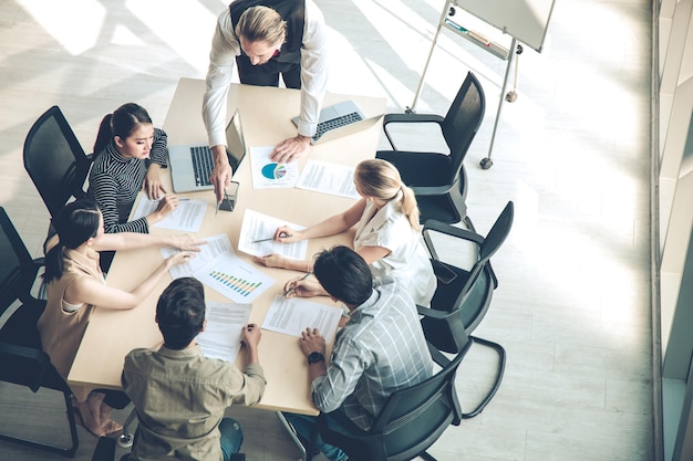 Top view of meetings and consultations of business people in the company's meeting room. Conference to analyze and find the progress of the organization. Team meeting to analyze assignments.