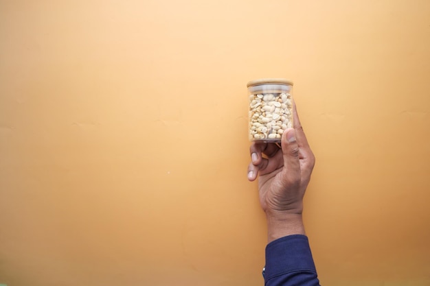 Top view of men holding peanut jar