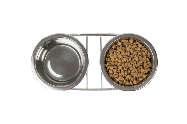 Top view of metal bowls with water and food isolated on a white background. Accessories for animals. Flat lay.