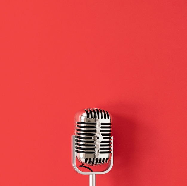 Photo top view microphone on red background