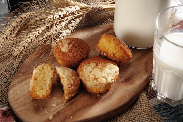 Top view of milk bottle with cookies on wooden board