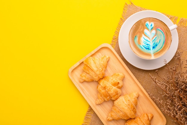 Top view mini Croissant in wooden dish and coffee. Food concept