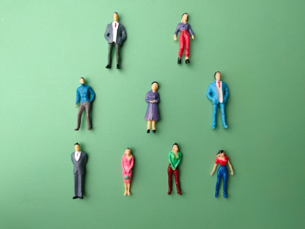 Top view miniature people on a green background