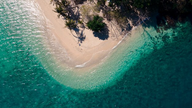 Top view of mixed clear green blue sea waving on curve beach island, Rayang island beach, travel destination in Trat, Thailand