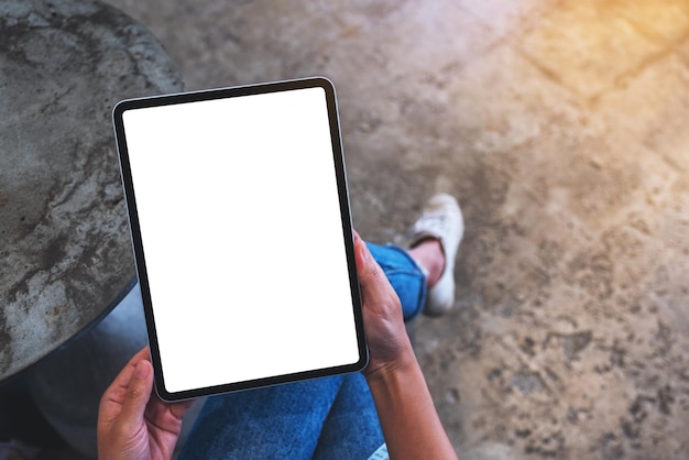 Top view mockup image of a woman holding digital tablet with blank white desktop screen