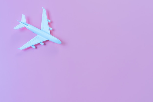 Top view of model plane, airplane on purple