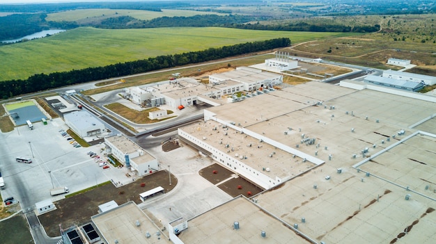 Top view of modern big factory with white buildings. Industrial complex. Aerial view.