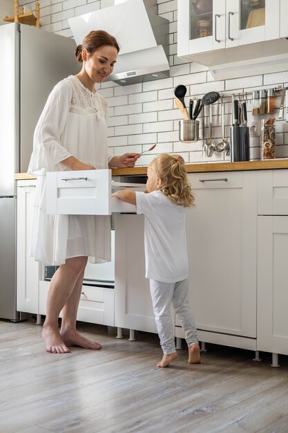 Top view modern housewife tidying up kitchen cupboard during general cleaning or tidying up