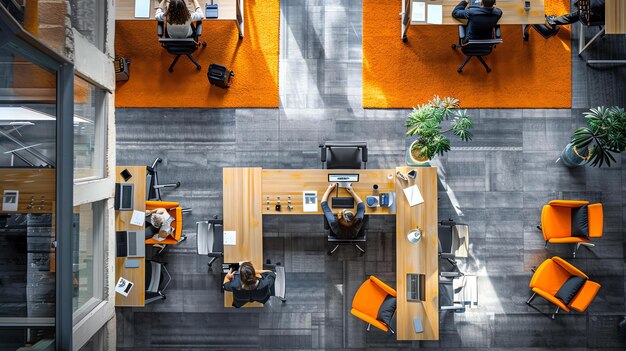 Top view of a modern office space with people working at their desks There are four people in the image three women and one man