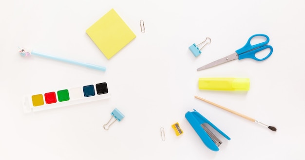 top view of modern white blue office desktop with school supplies and stationery