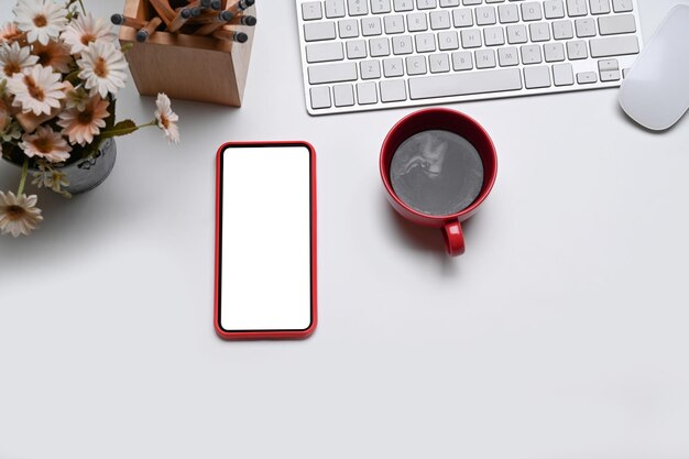 Top view modern workspace with coffee cup headphone notebooks\
and keyboard on white table