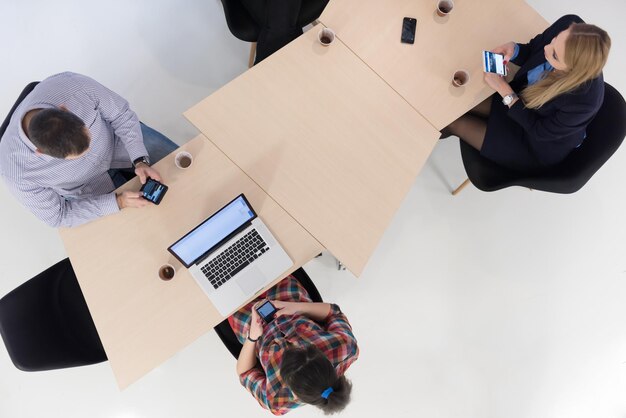 Photo top view of multi ethnic startup business people group on brainstorming meeting in modern bright office interior