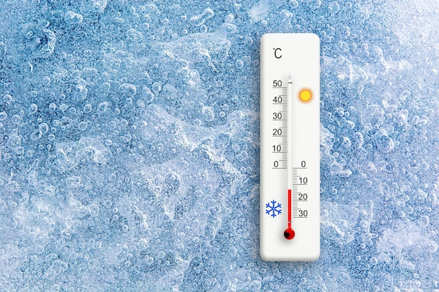 Photo top view of natural ice texture with celsius scale thermometer