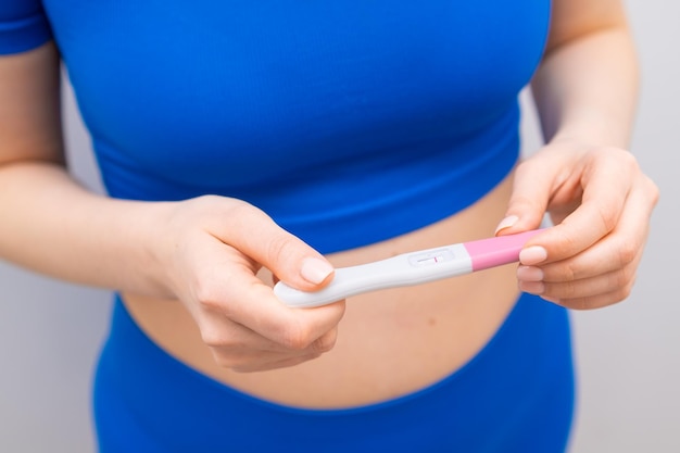 Top view on negative pregnancy test in woman hands