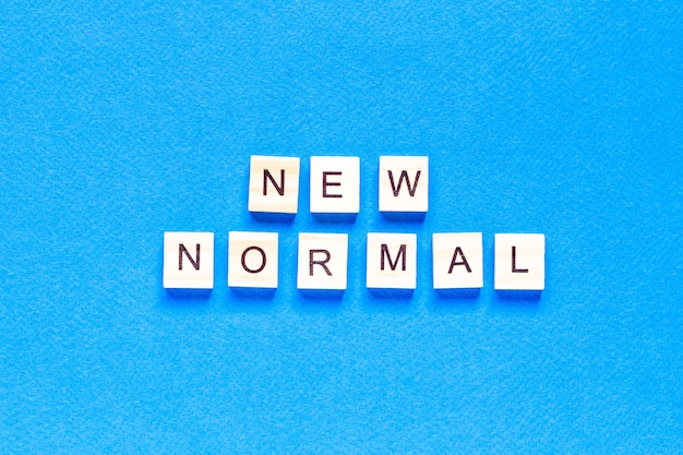 Top view new normal written with wooden letters