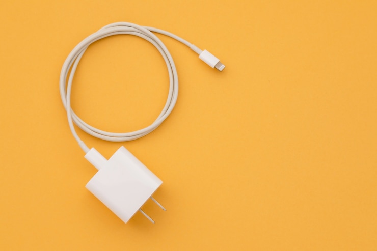 Photo top view new white smartphone charger