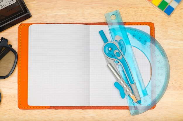 Top view of notebook with Compasses circle and eyeglasses