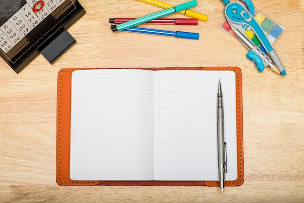 Top view of notebook with mechanical pencil and marker pen