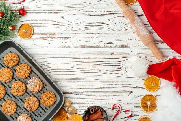 Top view of oat cookies in baking tray on wooden table