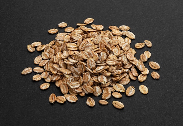 Top view of oat flakes on black background