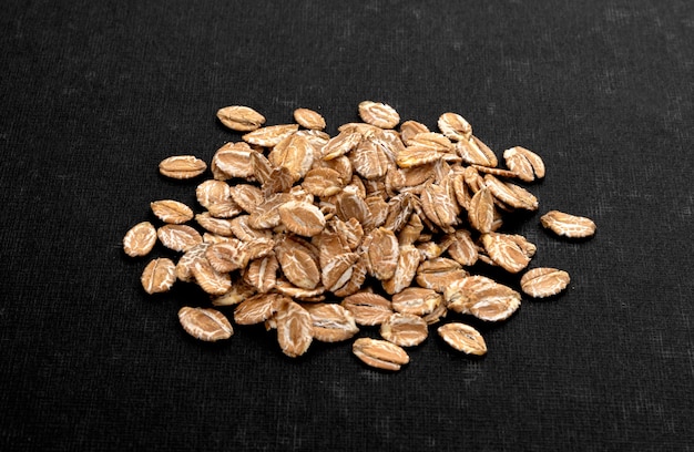 Top view of oat flakes on black background