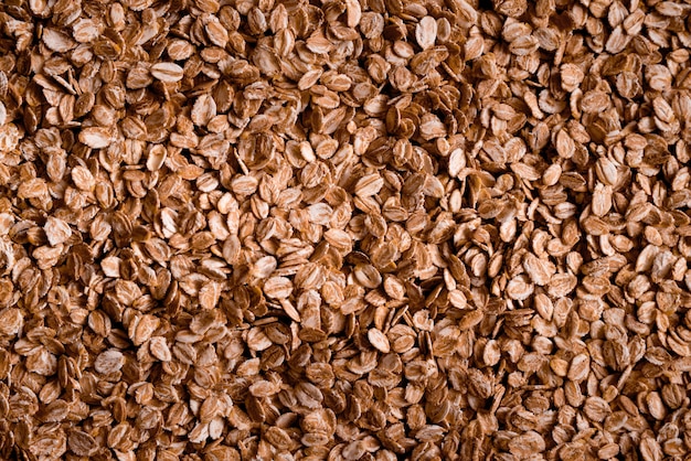 Top view of oat flakes, yellow hammer, oat ears