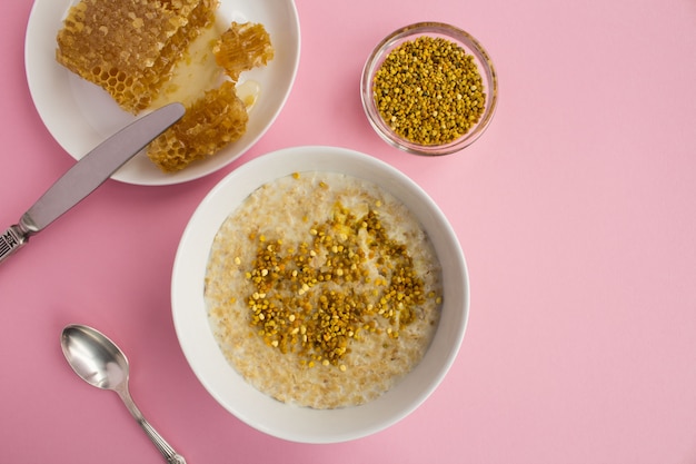 Top view of oatmeal with bee pollen and honey in bowl