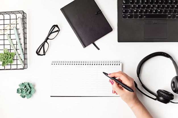 Top view of office desk. Table with laptop and office supplies. Flat lay home office workspace, remote work, distant learning, video conference, calls concept