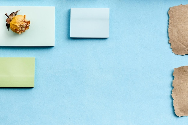 Top view of an office desk with stationery Stickers on a blue background