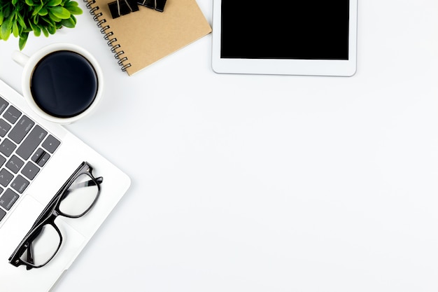 Top view of Office desk with workspace in office with blank notebook tablet and smartphone 