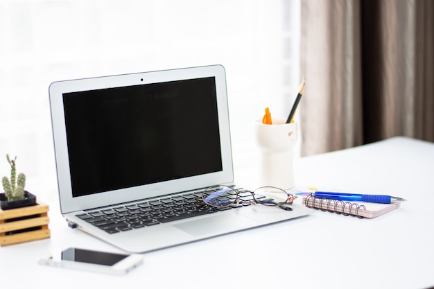 Top view of office desk workspace with coffee cup, notebook, smartphone and keyboard 