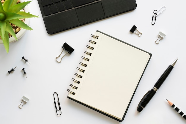 Top view of office stationery with notebook and laptop