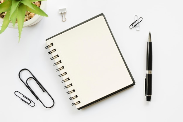 Top view of office stationery with paper clips and notebook