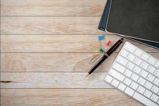 Top view of office supplies on wooden bakcground.