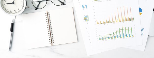 Top view of office table desk work concept with blank notebook