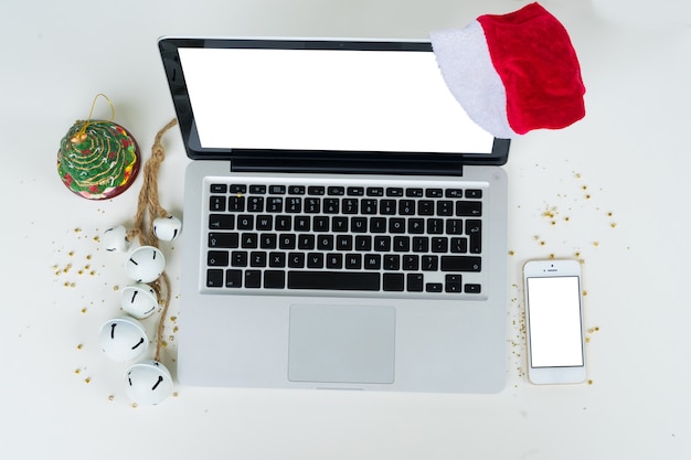 Top view office table desk. Workspace with laptop, mobile phone and christmas decorations 