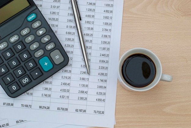 Top view office table with paper and coffee and calculator