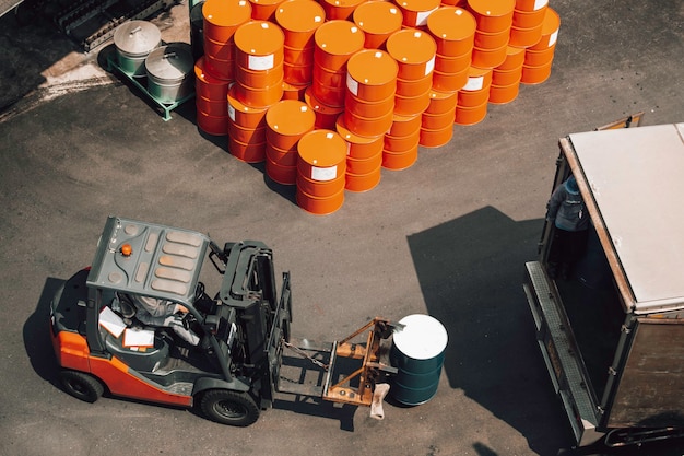 Top view oil barrels forklift truck move for on the transportation truck.