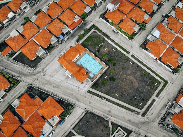 Top view of old european city with orange roofs. Lined up residential buildings with red tiled roofs