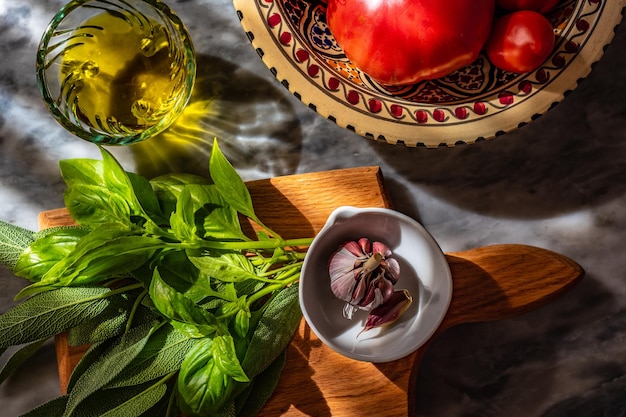 Top view of olive oil and fresh healthy vegetables on marble table