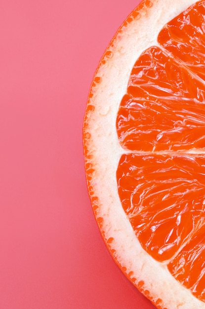 Top view of a one grapefruit slice on bright background