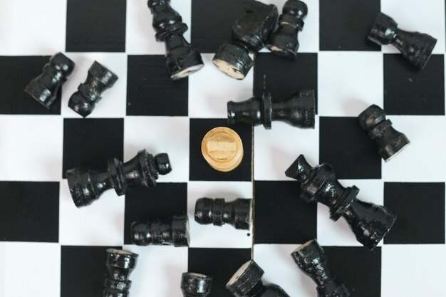 Photo top view of one king chess as a winner with black chess pieces falling on chessboard