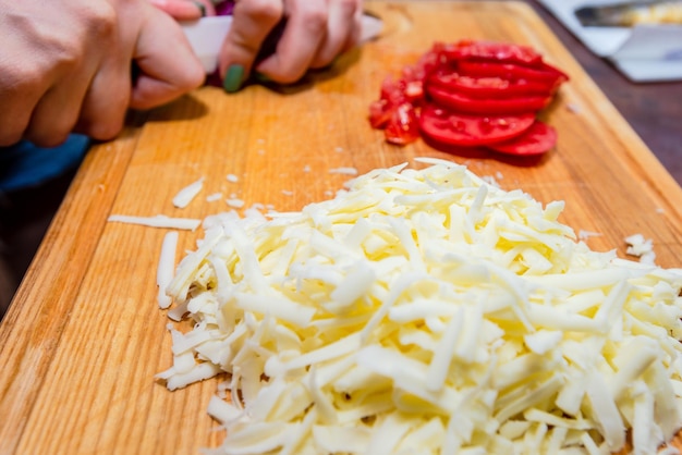 Top view of onion tomato and cheese on wooden cutting board healthy food