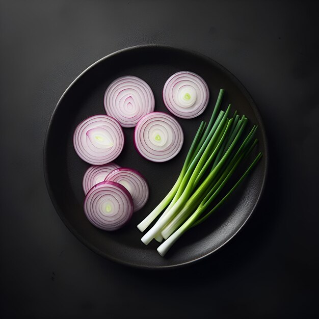 Top view of onions and green onions on a plate with dark background
