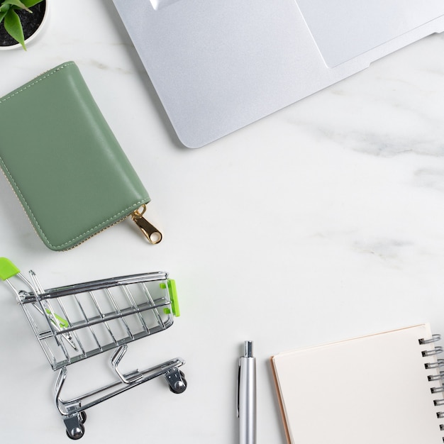 Top view of online shopping concept with credit card and laptop computer isolated on office marble white table background.