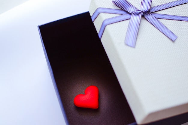 Top view of an open blue and white gift box or present box package with blue ribbon and bow