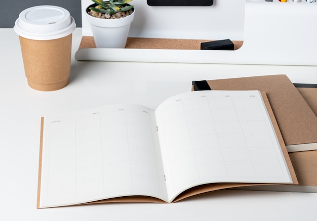 Top view of open calendar planner with modern office stationery