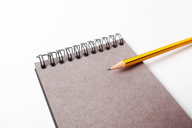 Photo top view open notebook and pencil potted on white background