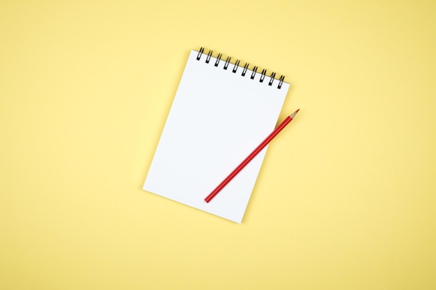 Top view of open spiral blank notebook on colorful desk